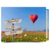 Cuadro en lienzo con texto personalizado: globo en forma de corazón y campo de flores con cartel para tu frase